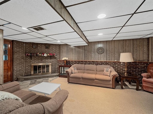 823 Clearview Dr, Penn Hills, PA 15147 - living room with carpet flooring, a drop ceiling, wood walls, and a brick fireplace