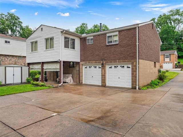 823 Clearview Dr, Penn Hills, PA 15147 - view of front of property with a storage shed, driveway, a garage, and brick siding