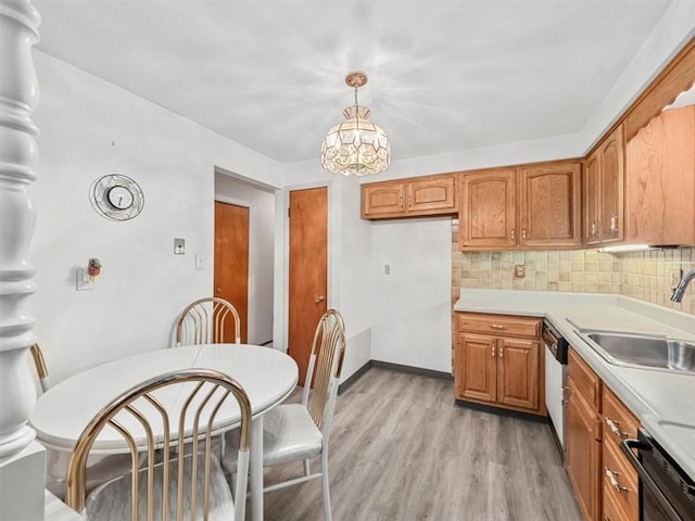 823 Clearview Dr, Penn Hills, PA 15147 - kitchen featuring light countertops, decorative backsplash, light wood-style floors, and brown cabinetry