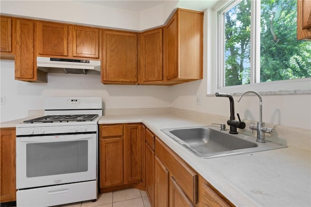 6623 Rosemoor St, Squirrel Hill, PA 15217 - kitchen with white gas stove, under cabinet range hood, plenty of natural light, and light countertops