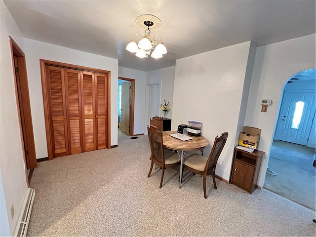 7 S Wabash St, Mount Pleasant Twp, PA 15361 - dining area with arched walkways, light colored carpet, baseboard heating, and a chandelier