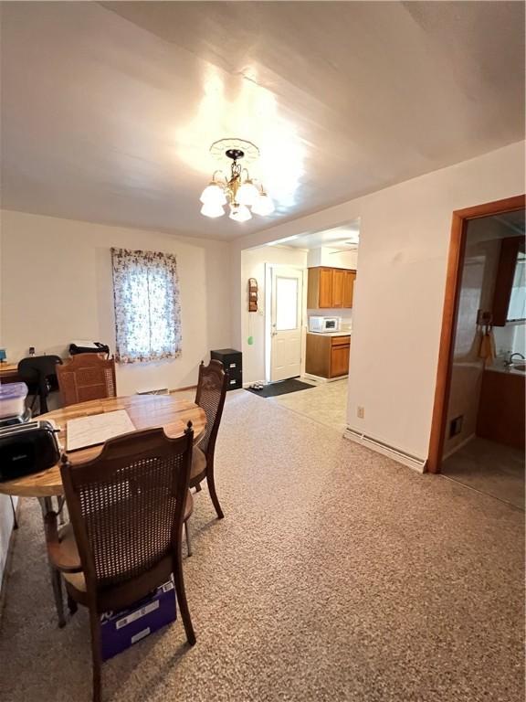 7 S Wabash St, Mount Pleasant Twp, PA 15361 - dining space with a chandelier and baseboards
