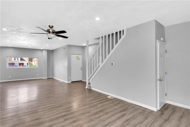 1406 Broadway Ave, Stowe Twp, PA 15136 - unfurnished living room featuring ceiling fan, stairs, wood finished floors, and recessed lighting