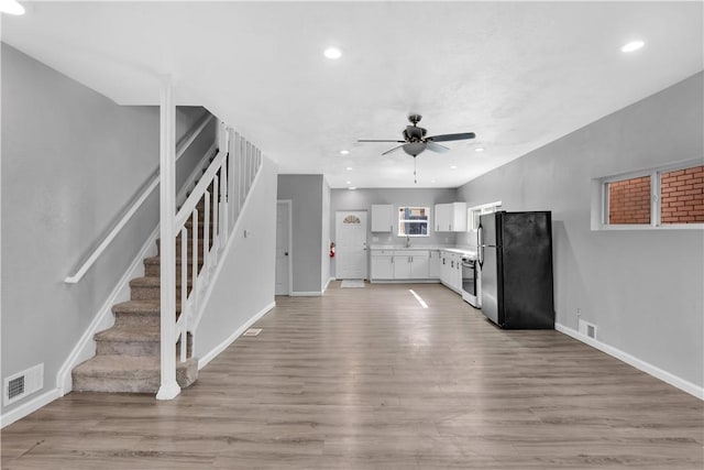 1406 Broadway Ave, Stowe Twp, PA 15136 - kitchen featuring freestanding refrigerator, a ceiling fan, white cabinetry, light countertops, and light wood-type flooring
