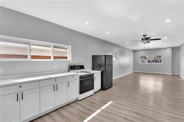 1406 Broadway Ave, Stowe Twp, PA 15136 - kitchen featuring white range with gas cooktop, freestanding refrigerator, a ceiling fan, recessed lighting, and light wood finished floors