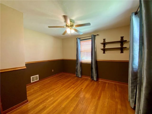 90 Steubenville Pike, Hanover Twp, PA 15021 - unfurnished room featuring wood finished floors, ceiling fan, and a wainscoted wall