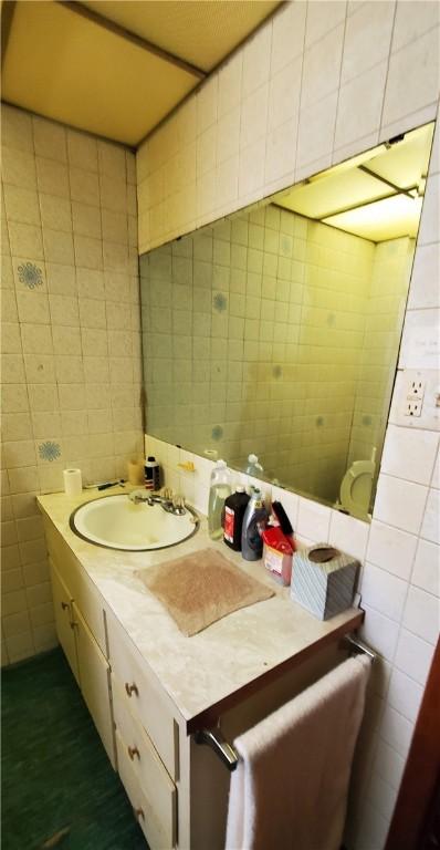 705 Carlisle St, New Castle, PA 16101 - bathroom featuring tile walls, vanity, and tile patterned flooring