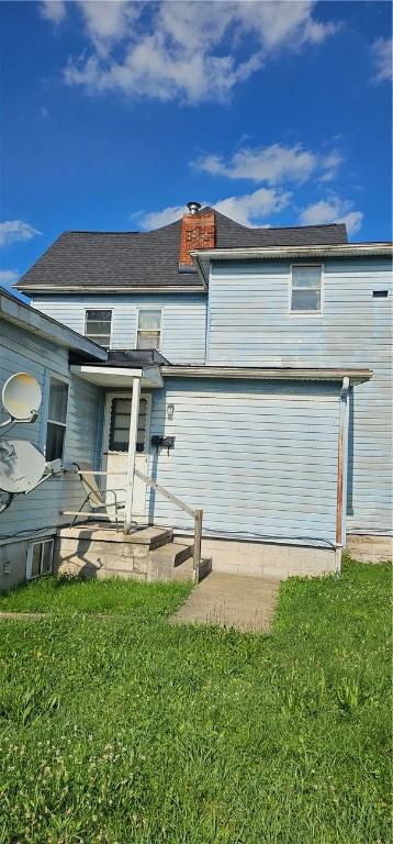 705 Carlisle St, New Castle, PA 16101 - back of house with a chimney and a yard