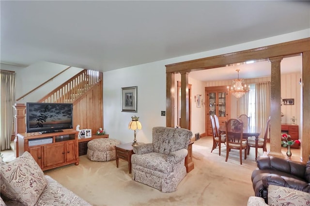 1020 Adams St, New Castle, PA 16101 - living room with a chandelier, light colored carpet, stairs, and decorative columns
