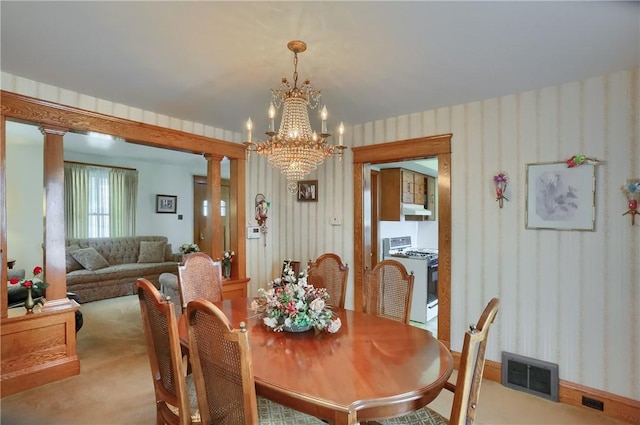 1020 Adams St, New Castle, PA 16101 - dining area featuring a chandelier, light carpet, wallpapered walls, and ornate columns