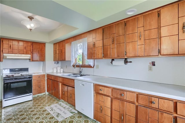 1020 Adams St, New Castle, PA 16101 - kitchen featuring white appliances, under cabinet range hood, light countertops, and brown cabinets