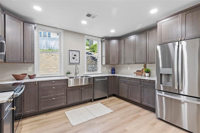 241 S Starr Ave, Avalon, PA 15202 - kitchen featuring appliances with stainless steel finishes, light countertops, light wood-type flooring, dark brown cabinetry, and recessed lighting