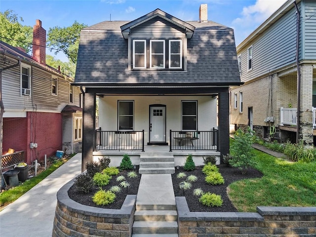 241 S Starr Ave, Avalon, PA 15202 - dutch colonial featuring a shingled roof, a porch, brick siding, and a chimney