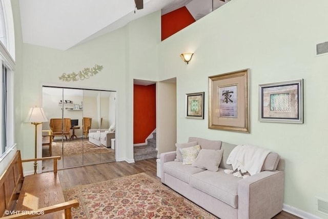 9810 Three Degree Rd, Mccandless, PA 15101 - living room featuring high vaulted ceiling, wood finished floors, and stairway