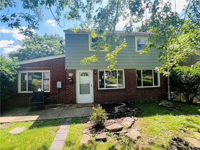 543 Burton Dr, Penn Hills, PA 15235 - back of house featuring brick siding, a patio, and a yard