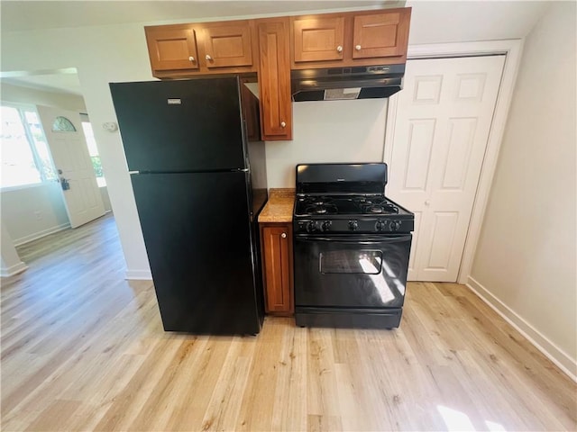 543 Burton Dr, Penn Hills, PA 15235 - kitchen featuring black appliances, under cabinet range hood, light wood-style floors, and brown cabinets