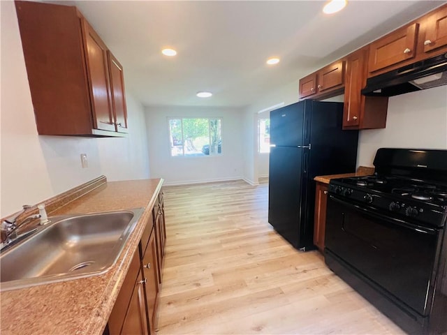 543 Burton Dr, Penn Hills, PA 15235 - kitchen featuring black appliances, under cabinet range hood, light wood finished floors, brown cabinets, and recessed lighting