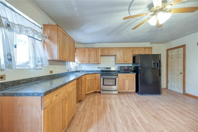 75 Wilson St, Etna, PA 15223 - kitchen with black appliances, light wood-type flooring, dark countertops, and a ceiling fan