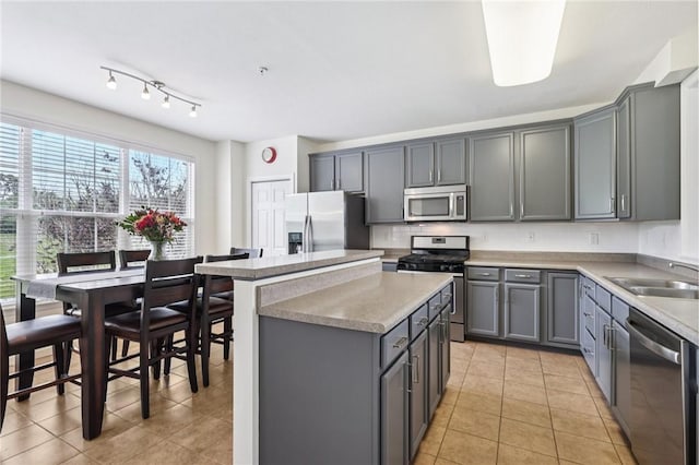 10495 Timber Edge Dr, Mccandless, PA 15090 - kitchen featuring appliances with stainless steel finishes, gray cabinets, a kitchen island, light tile patterned floors, and light countertops