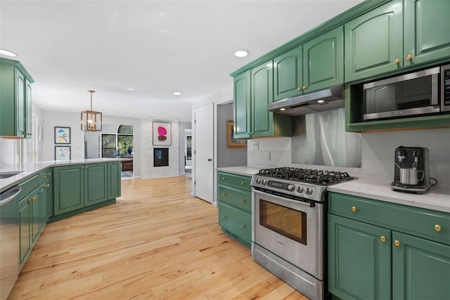 32 Canter Dr, Sewickley Hills Boro, PA 15143 - kitchen featuring appliances with stainless steel finishes, under cabinet range hood, light countertops, recessed lighting, and light wood-type flooring