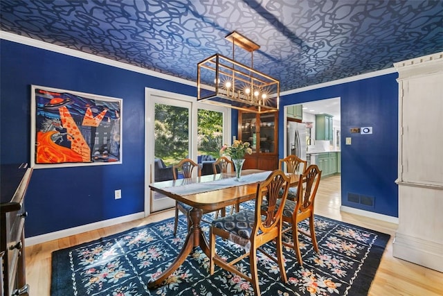 32 Canter Dr, Sewickley Hills Boro, PA 15143 - dining space featuring a chandelier, crown molding, an ornate ceiling, and light wood finished floors