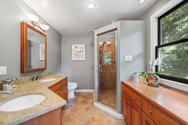 32 Canter Dr, Sewickley Hills Boro, PA 15143 - bathroom with double vanity, a stall shower, and stone finish floors