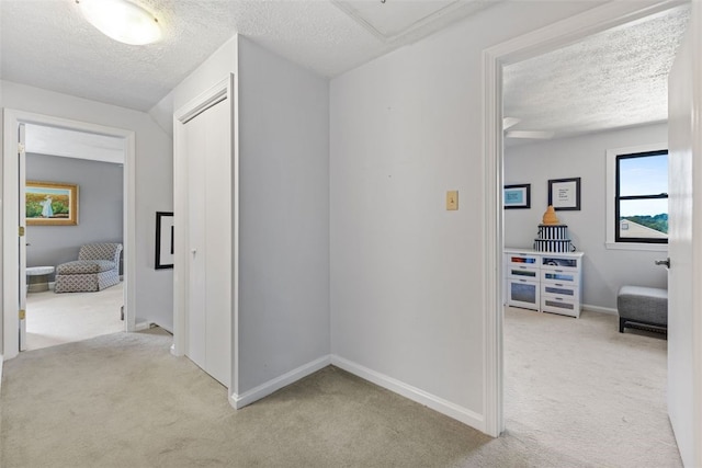 32 Canter Dr, Sewickley Hills Boro, PA 15143 - corridor with light colored carpet, a textured ceiling, and attic access