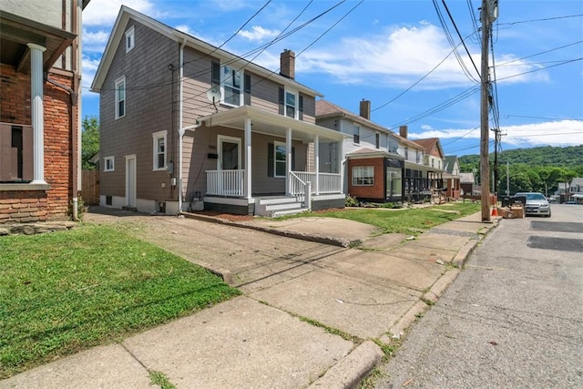 1106 Wade St, Aliquippa, PA 15001 - view of front of property with covered porch and a chimney