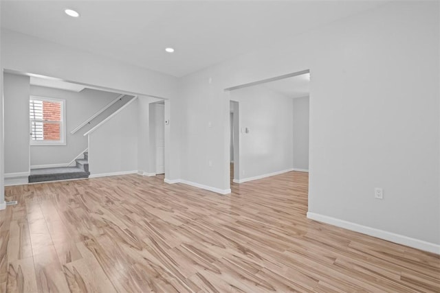 1106 Wade St, Aliquippa, PA 15001 - unfurnished living room featuring light wood-type flooring, stairway, and recessed lighting