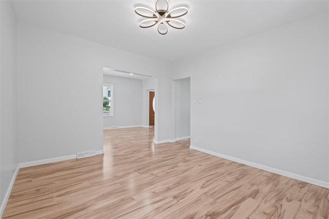 1106 Wade St, Aliquippa, PA 15001 - spare room featuring a chandelier and light wood-type flooring
