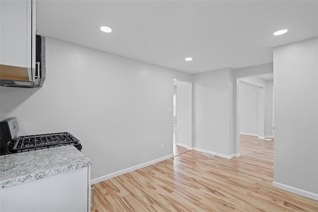 1106 Wade St, Aliquippa, PA 15001 - kitchen featuring light countertops, light wood finished floors, stainless steel range with gas stovetop, recessed lighting, and white cabinetry