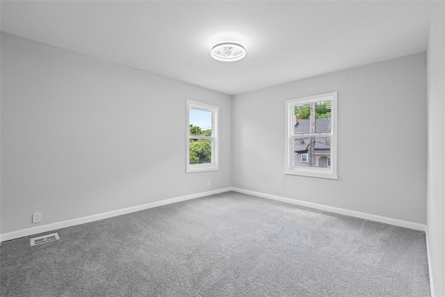1106 Wade St, Aliquippa, PA 15001 - empty room with healthy amount of natural light and carpet floors