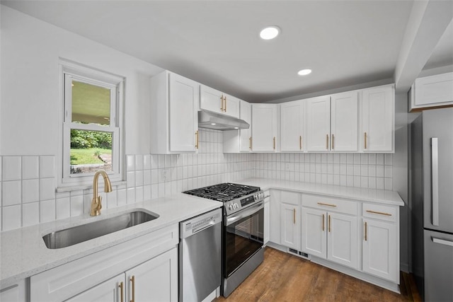 332 Garlow Dr, Penn Hills, PA 15235 - kitchen with stainless steel appliances, under cabinet range hood, white cabinetry, light stone countertops, and recessed lighting