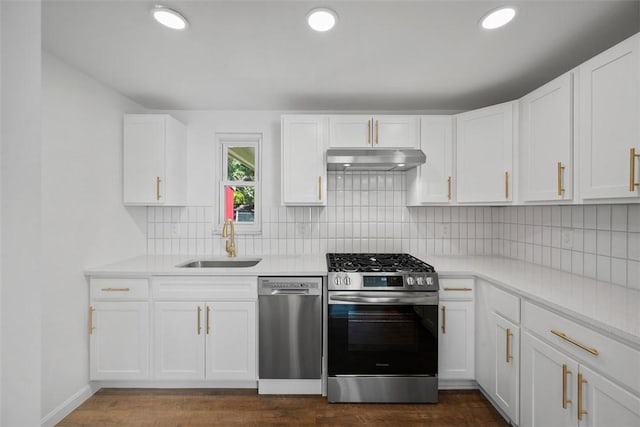 332 Garlow Dr, Penn Hills, PA 15235 - kitchen with stainless steel appliances, under cabinet range hood, light countertops, decorative backsplash, and white cabinets