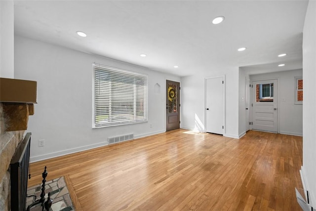 332 Garlow Dr, Penn Hills, PA 15235 - unfurnished living room featuring a stone fireplace, light wood-style floors, and recessed lighting