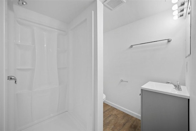 332 Garlow Dr, Penn Hills, PA 15235 - bathroom featuring vanity, a shower, and wood finished floors