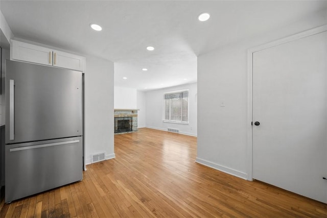 332 Garlow Dr, Penn Hills, PA 15235 - unfurnished living room with light wood-type flooring, a fireplace, and recessed lighting