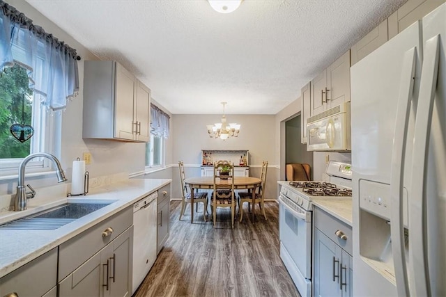 4044 Tuxey Ave, Brentwood, PA 15227 - kitchen with white appliances, gray cabinetry, a chandelier, dark wood-style flooring, and light countertops