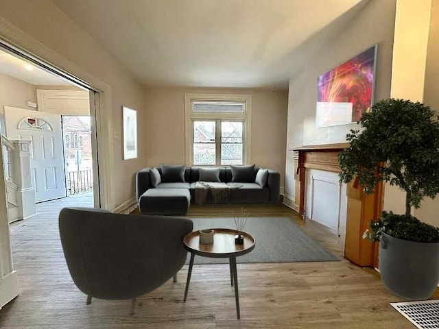 5404 Black St, Garfield, PA 15206 - living area featuring light wood finished floors and a fireplace