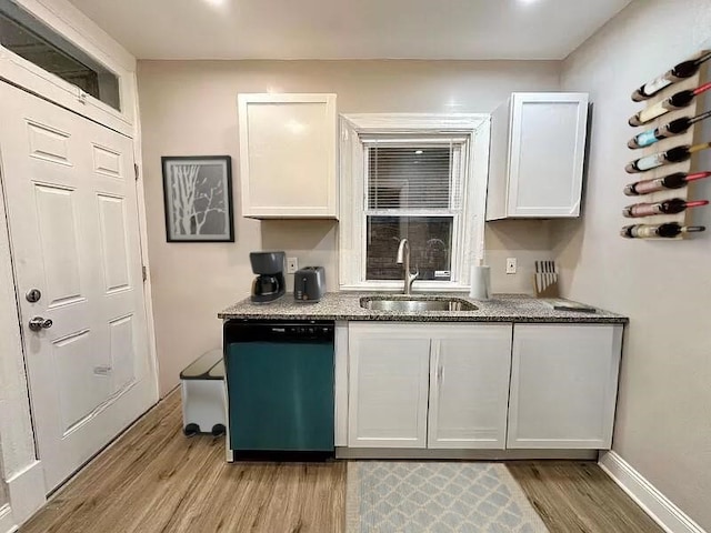 5404 Black St, Garfield, PA 15206 - kitchen with dishwashing machine, light wood-type flooring, white cabinets, and stone counters