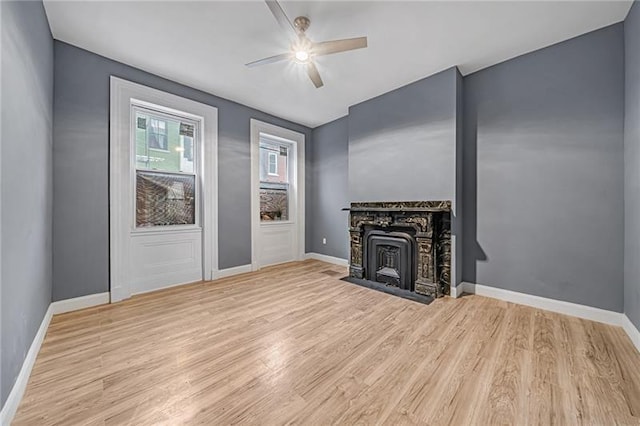1221 Boyle St, East Allegheny, PA 15212 - unfurnished living room with wood finished floors, a ceiling fan, and a fireplace with flush hearth