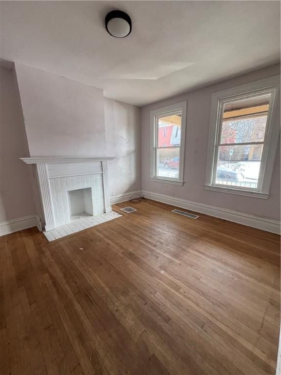 1238 Superior Ave, Marshall Shadeland, PA 15212 - unfurnished living room with wood-type flooring, healthy amount of natural light, and a tiled fireplace