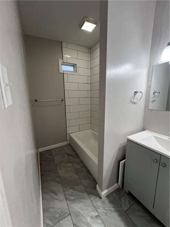 1238 Superior Ave, Marshall Shadeland, PA 15212 - bathroom featuring marble look tiles, vanity, and  shower combination