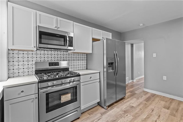 363 44th St, Lawrenceville, PA 15201 - kitchen featuring stainless steel appliances, light countertops, backsplash, and light wood-style flooring