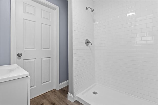 363 44th St, Lawrenceville, PA 15201 - bathroom with a tile shower, wood finished floors, and vanity