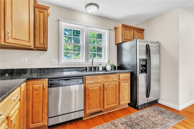 1109 Mary Ann, South Side, PA 15203 - kitchen with stainless steel appliances, light wood-style floors, and brown cabinets