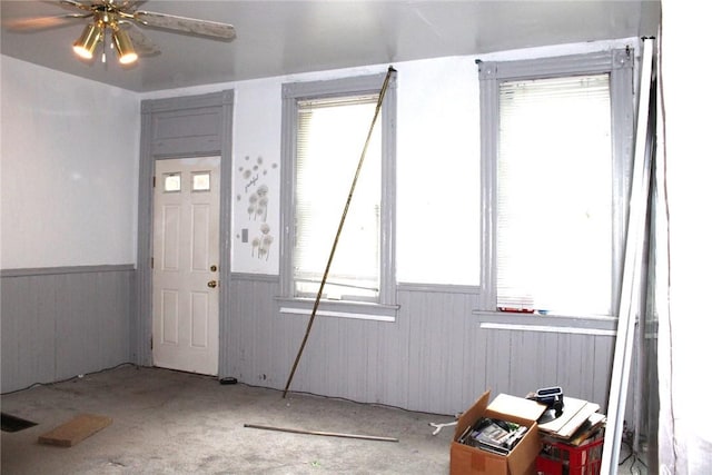 5388 Warble St, Garfield, PA 15224 - carpeted entryway featuring a wainscoted wall, wood walls, healthy amount of natural light, and ceiling fan