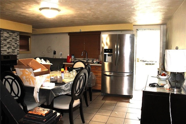 5388 Warble St, Garfield, PA 15224 - kitchen with stainless steel fridge and light tile patterned floors