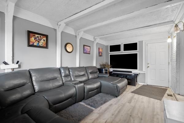 147 Rodilin Dr, Penn Hills, PA 15235 - living area with wood finished floors, beamed ceiling, and a textured ceiling