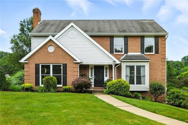 109 Hamilton Ct, Economy, PA 15005 - view of front of home with a chimney, brick siding, a front lawn, and roof with shingles